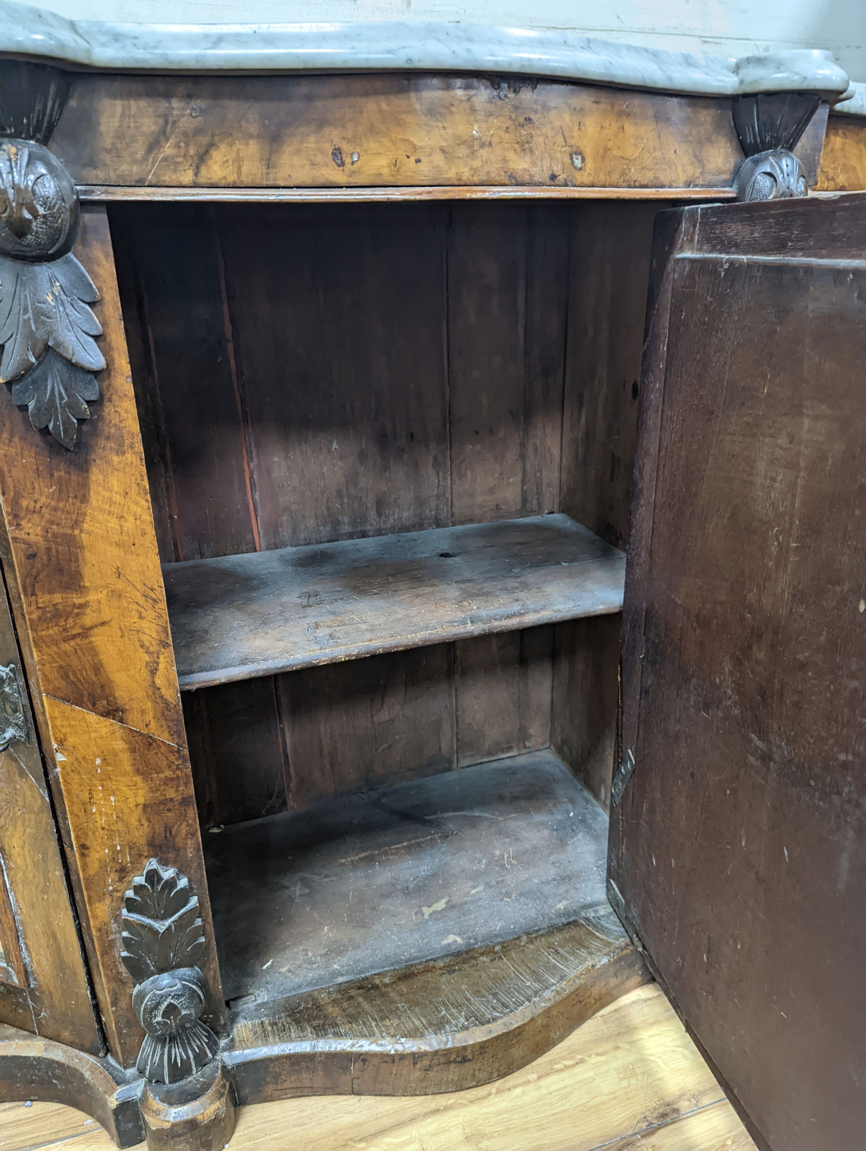 A late Victorian walnut and marble topped serpentine front side cabinet, width 120cm, depth 36cm, height 83cm